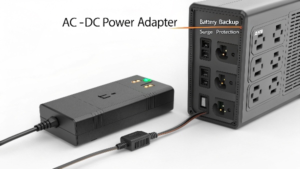 A generic AC-DC power adapter (power supply) next to a complex UPS unit, highlighting the UPS's additional features